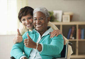 Nurse and patient smiling and giving a thumb up.